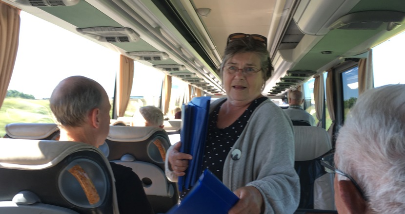 Monika delar ut infopärm i bussen