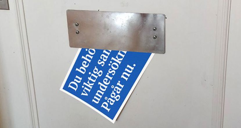 Brev som halvvägs syns i ett brevinkast i en vit dörr.